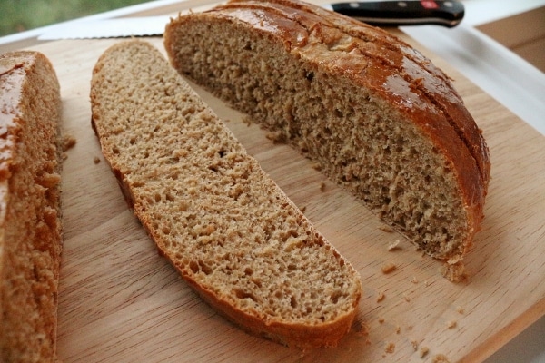 a closeup of sliced brown bread on a wooden board