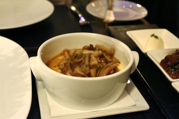 cooked mushrooms in a white bowl on a table