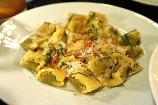 a plate of stuffed pasta with cheese grated over the top