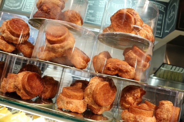 a store display with glass containers filled with pastries