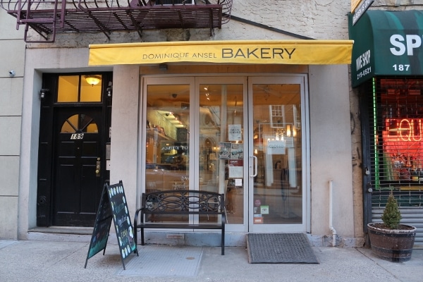 exterior of Dominique Ansel Bakery with a yellow awning over the storefront