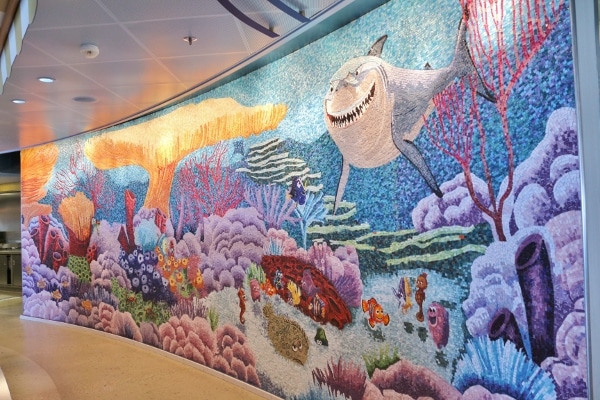 a colorful underwater themed tile mosaic with a shark, fish, and plants