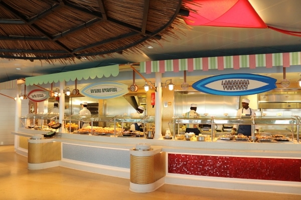 a beach themed restaurant buffet with surf board signs over each station