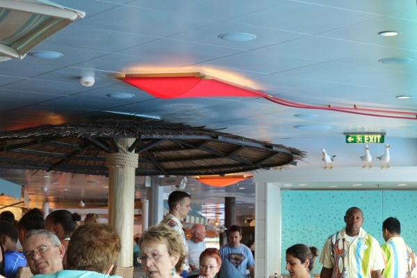 a red kite attached to a tiled ceiling in a restaurant