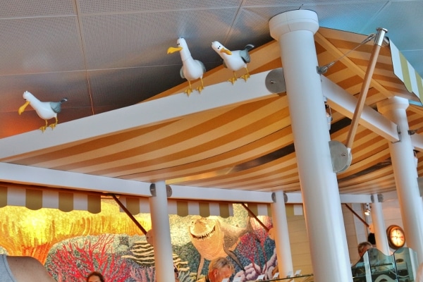 seagull statues on top of a white wooden beam
