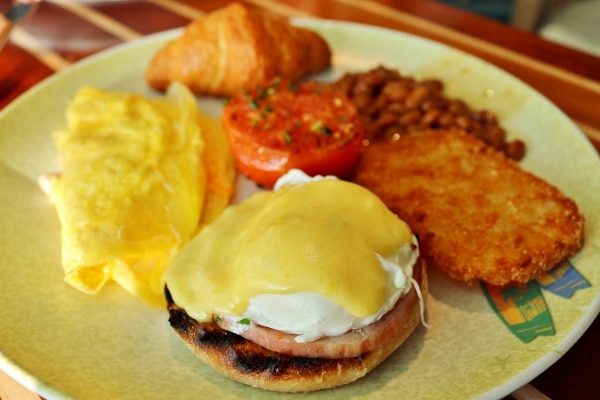 a closeup of a plate of breakfast foods including eggs benedict