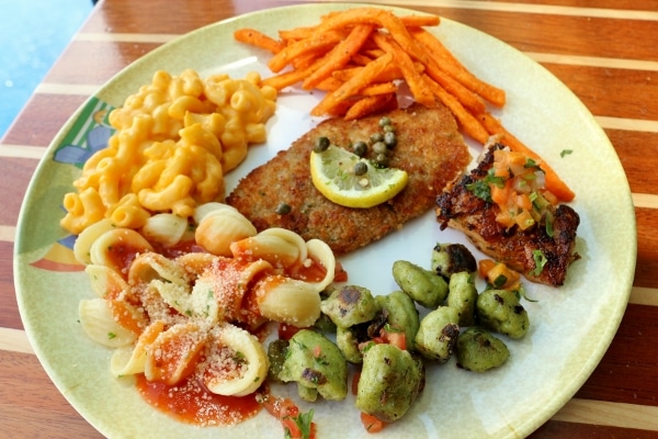 a plate of food including pasta and fish from a lunch buffet