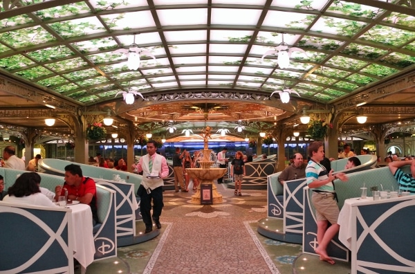 the bustling interior of the Enchanted Garden dining room on the Disney Fantasy cruise ship