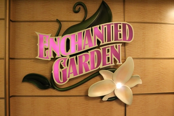 a lit sign that says Enchanted Garden