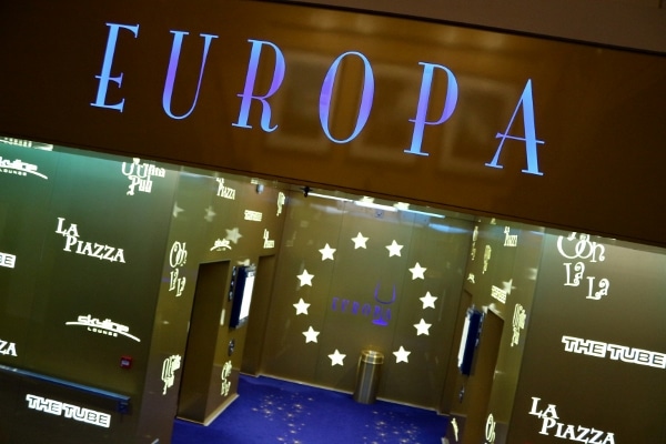 a sign that says Europa over a bank of elevators