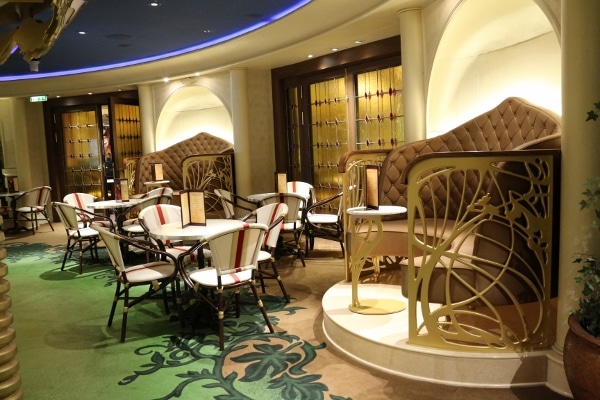 a sitting area in a European style bar with tables and chairs