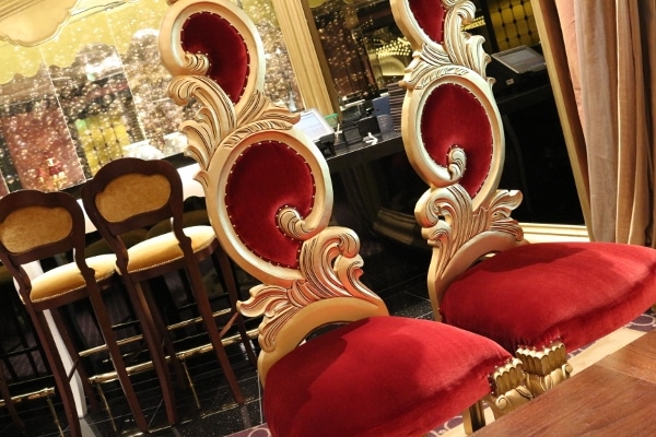 two red and gold regal looking chairs