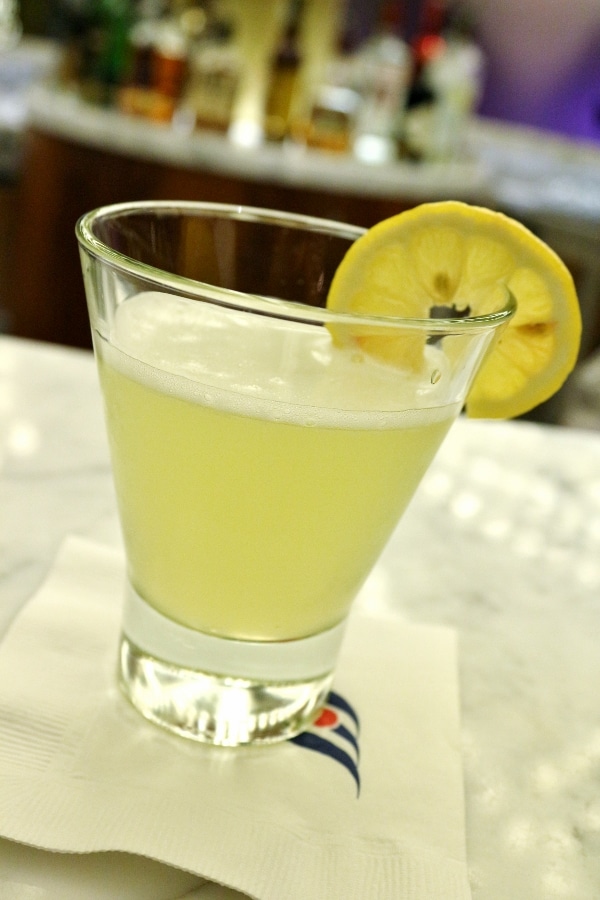 A drink in a short glass with a lemon slice garnish