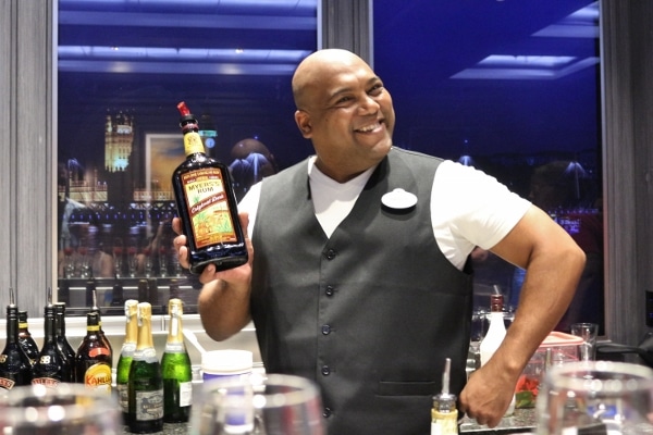 A man holding a bottle of Meyers Dark Rum