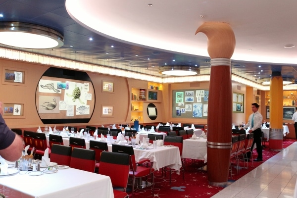 interior of a cruise ship restaurant with giant paint brush shaped columns