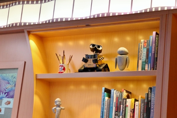 shelves of books and a Wall-E statue