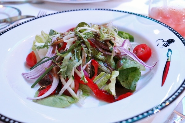 A plate of salad with tomatoes and red onion