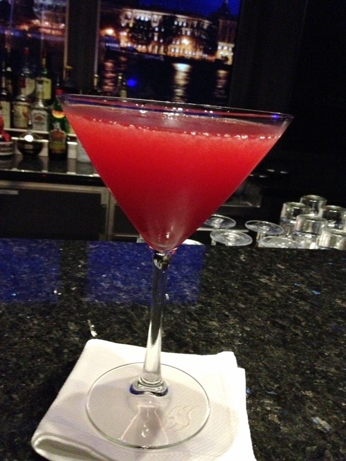 A bright red drink in a cocktail glass