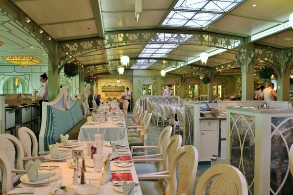 a cruise ship dining room with pale green decorations