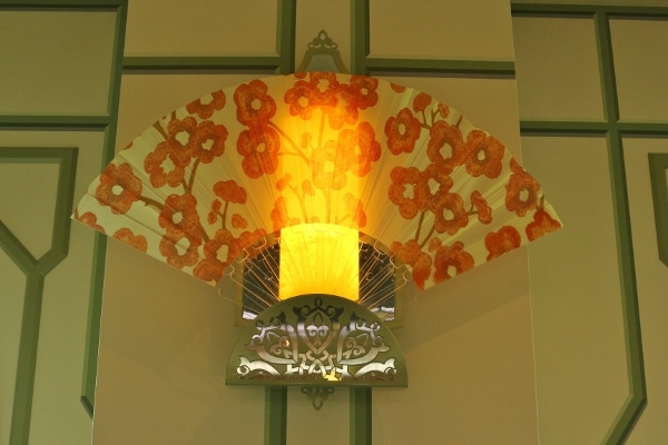 a floral fan covered a lighting fixture in the wall