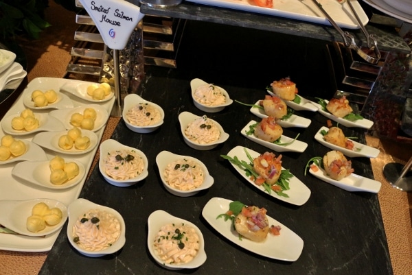 small white dishes of food on a black tablecloth