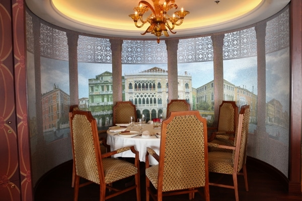 A dining table under a gold chandelier