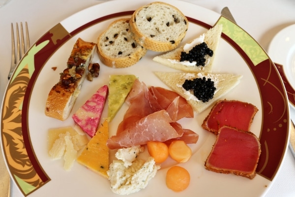 overhead view of a plate of cured meats, cheeses, and bread