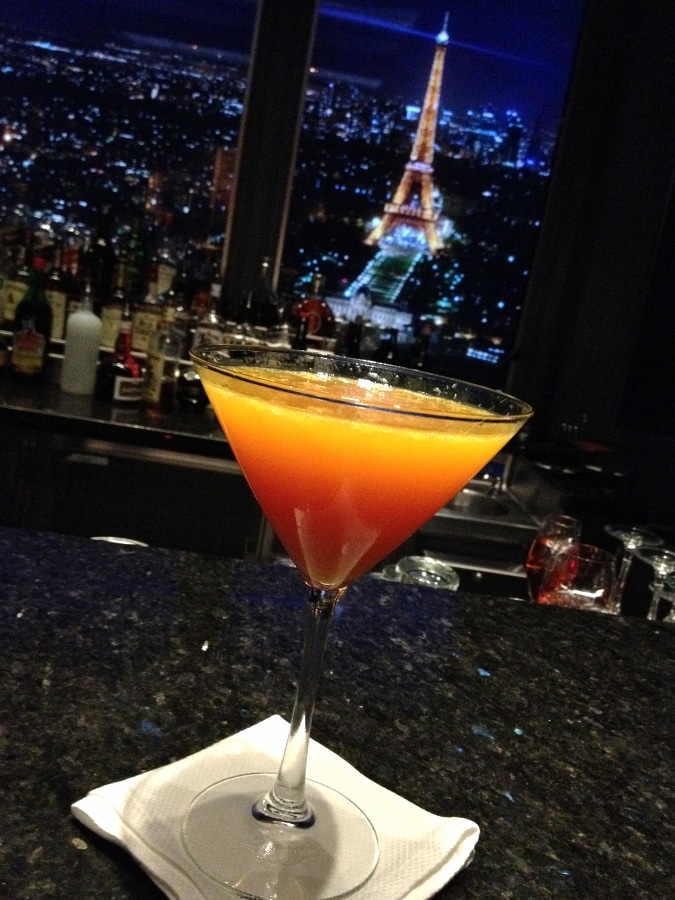 a yellow, orange, and red layered cocktail in a glass
