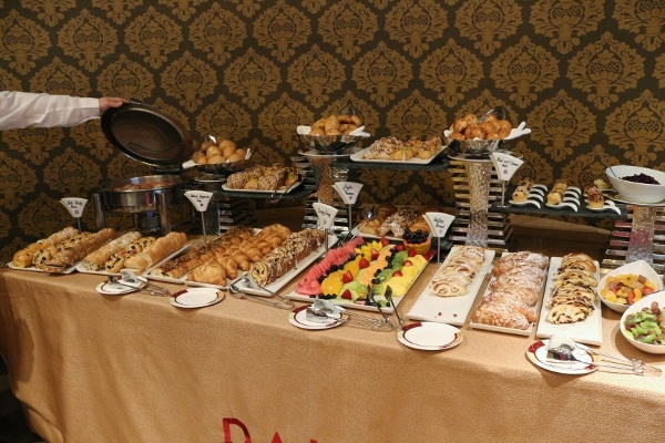 a buffet of various baked goods and fruits