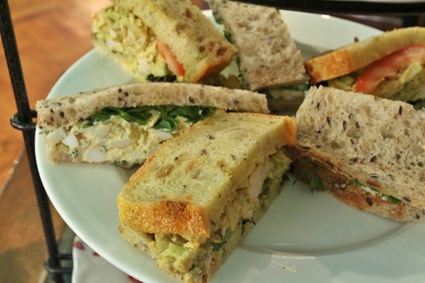 a variety of sandwich halves on a white plate