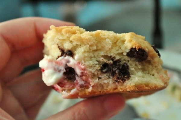 A close up of a half eaten scone in someone\'s hand