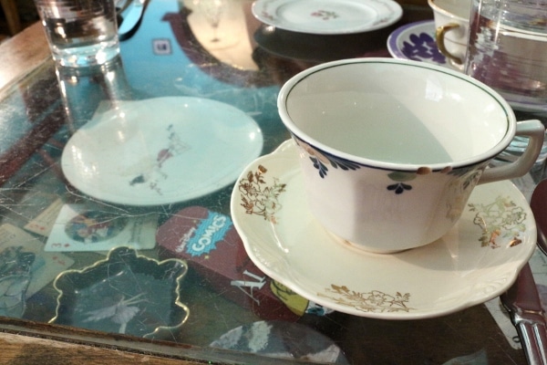 A teacup and saucer on a colorful table