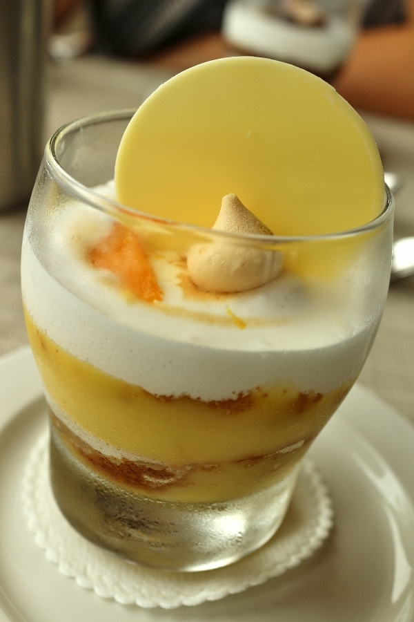 a closeup of a lemon meringue parfait in a glass container