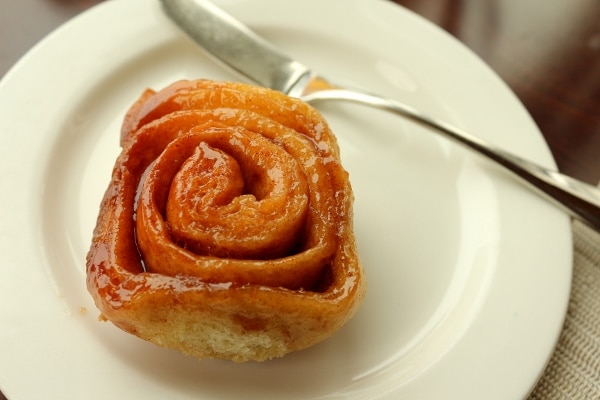 a sticky bun on a small white plate