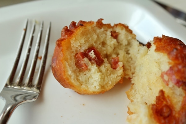 a cross section of a fried fritter with pieces of chorizo meat inside