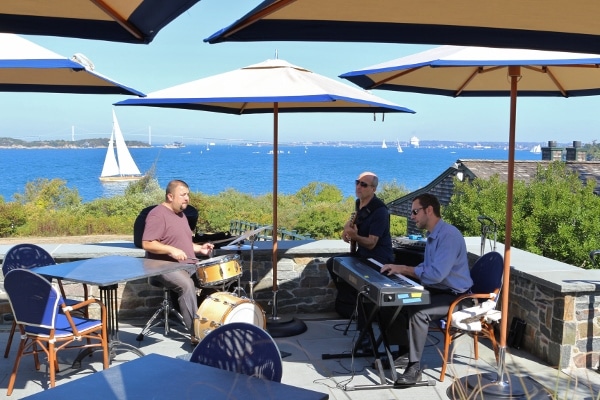 A group of musicians performing near the waterfront