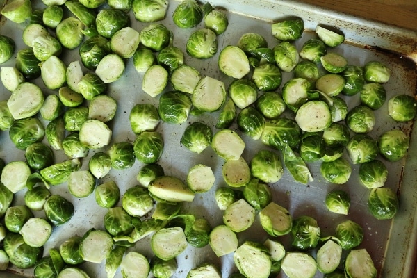 uncooked brussels sprouts on a metal baking sheet