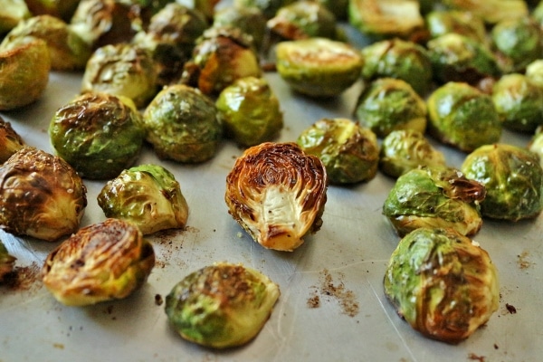 A closeup of roasted brussels sprouts on a baking sheet