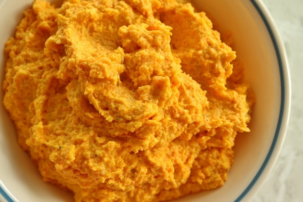 creamy orange-colored carrot ravioli filling in a bowl