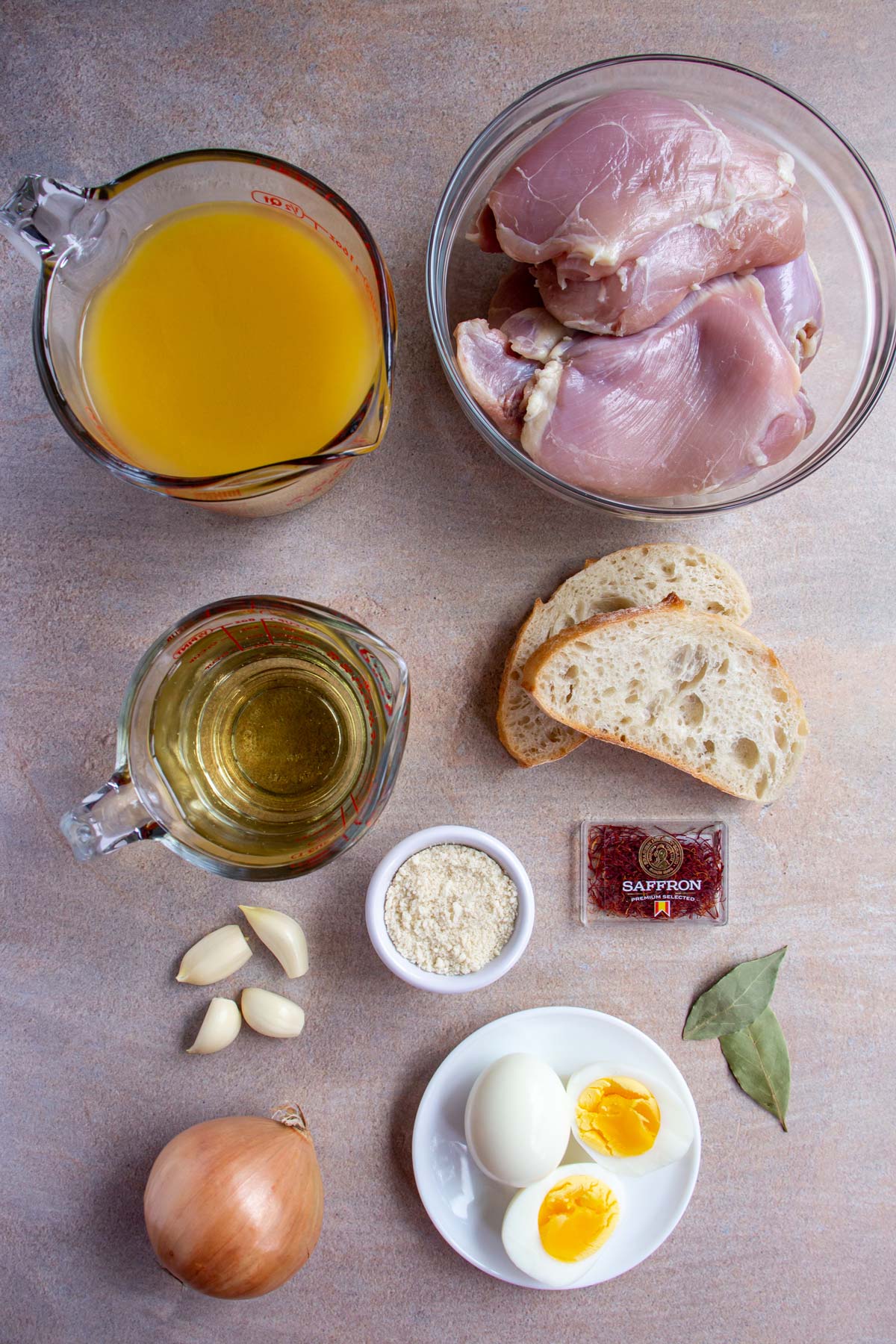 Ingredients for pollo en pepitoria on a warm beige background.