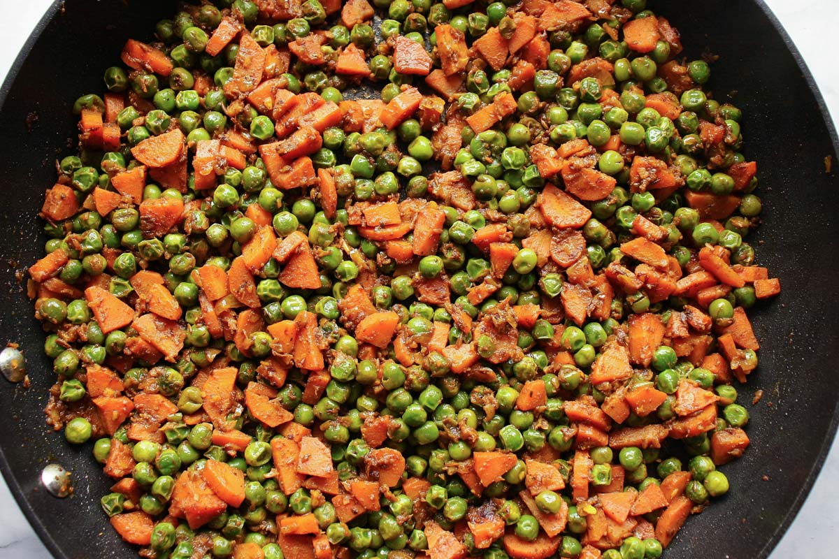 Indian gajar matar carrots and peas in a nonstick skillet.