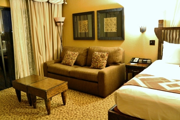 a small sofa and coffee table in a hotel room