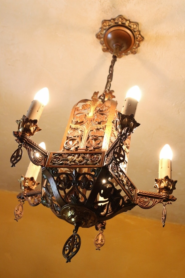 a metal chandelier hanging from the ceiling