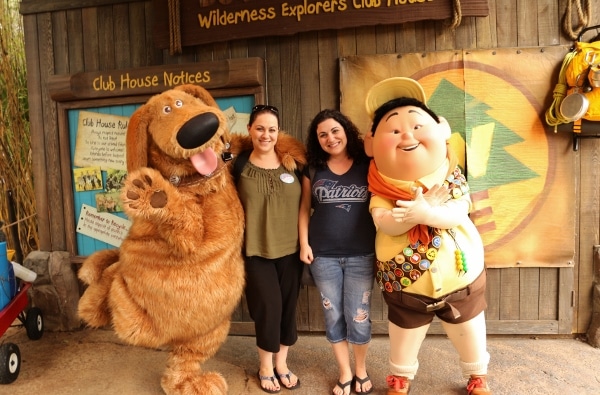 two women posing with Dug and Russell from Disney\'s Up! movie