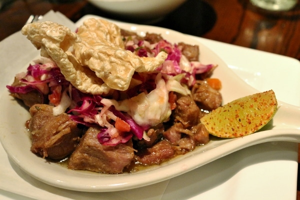 A close up of a plate of pork carnitas