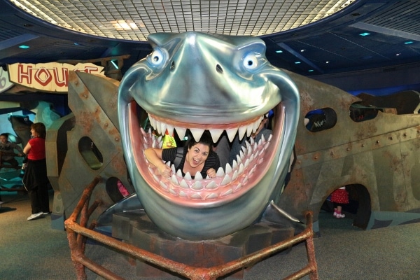 a woman posing inside a fake shark\'s mouth