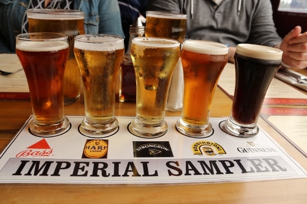 a flight of beer lined up on a labeled sheet