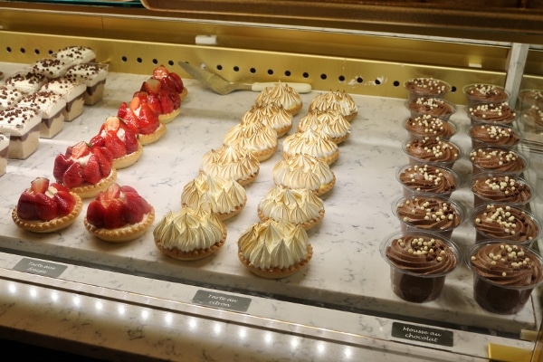 rows of pastries and desserts in a display case