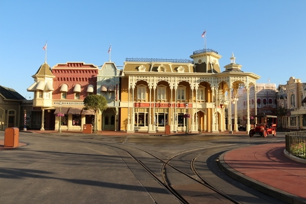 buildings on Main Street USA with an old-fashioned car driving by
