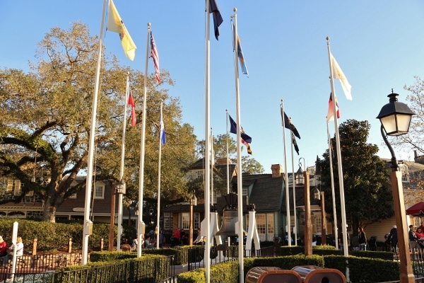 a group of flag poles with different flags flying on them